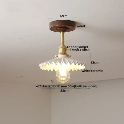 DecorBites™ ceiling light with dark wood base, brass socket, and white ceramic shade with scalloped edge design