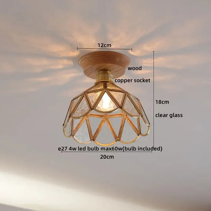 A warm-toned amber glass led ceiling light with a geometric design wooden base and copper socket for modern decor
