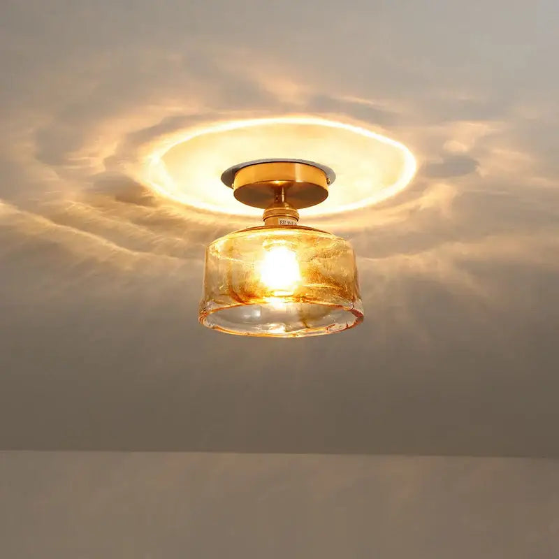 DecorBites™ amber glass LED ceiling light with warm-toned textured glass shade and brass-finished copper socket mounting base