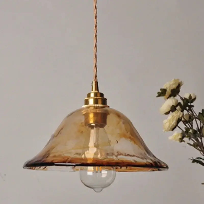 Decorbites amber glass pendant light fixture with warm amber glass shade, brass finish, and twisted cord hanging lamp