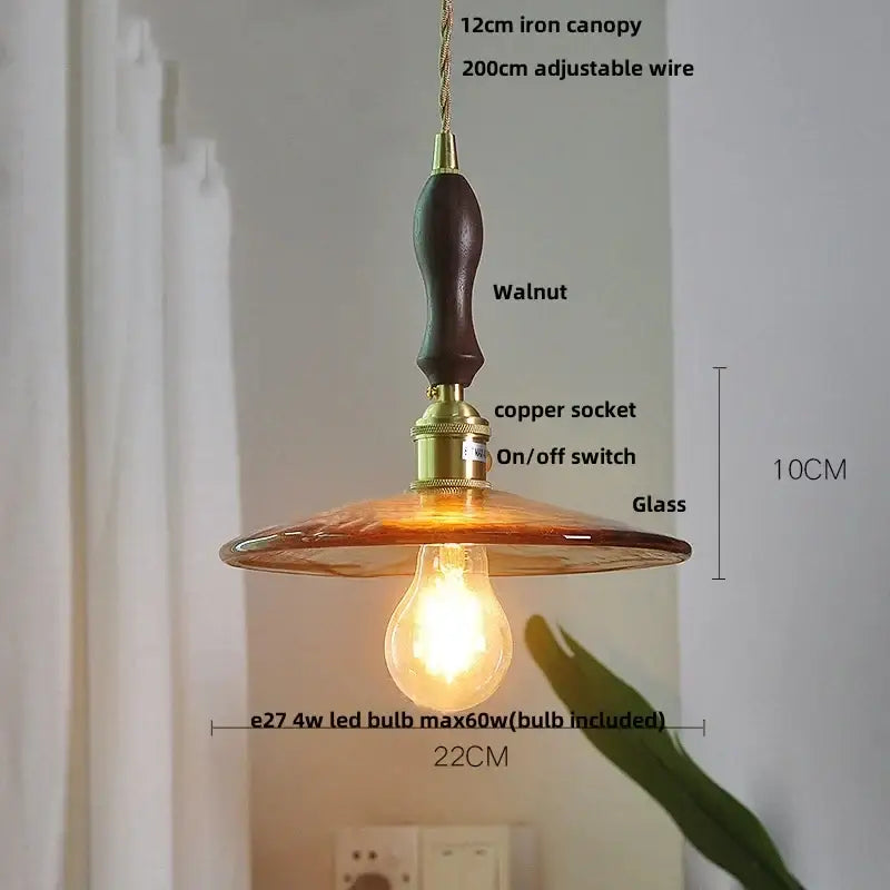 Decorbites amber glass pendant light fixture with warm amber glass, dark walnut iron canopy, and brass hardware