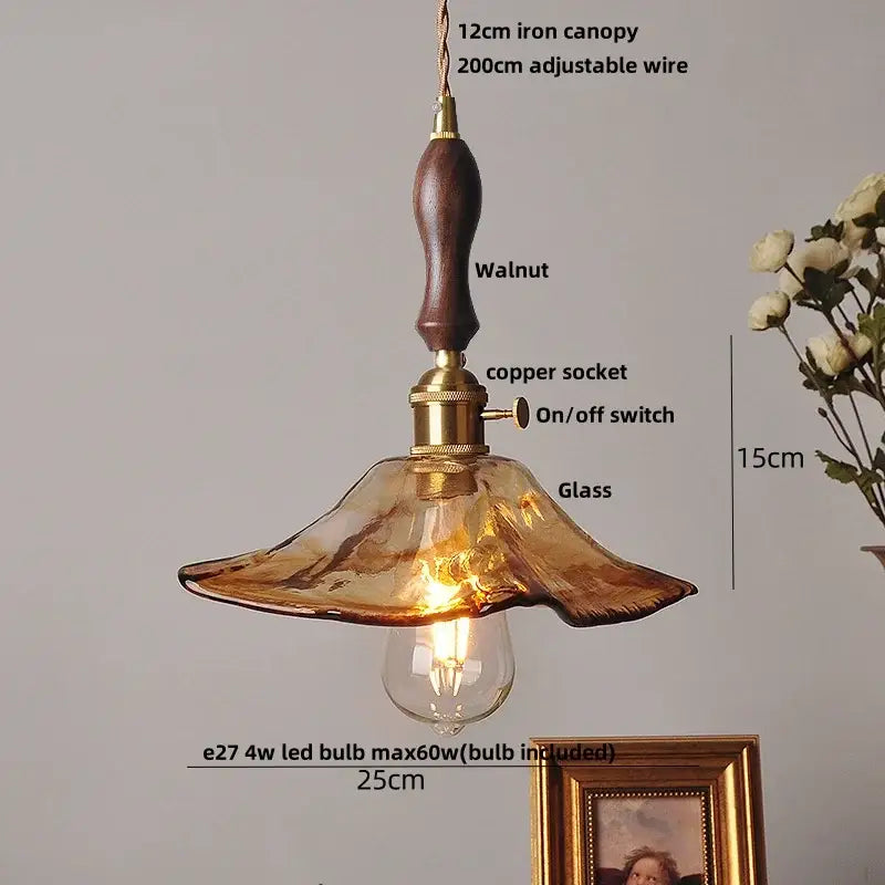 Decorbites amber glass pendant light fixture with warm amber glass, walnut iron canopy, and brass accents