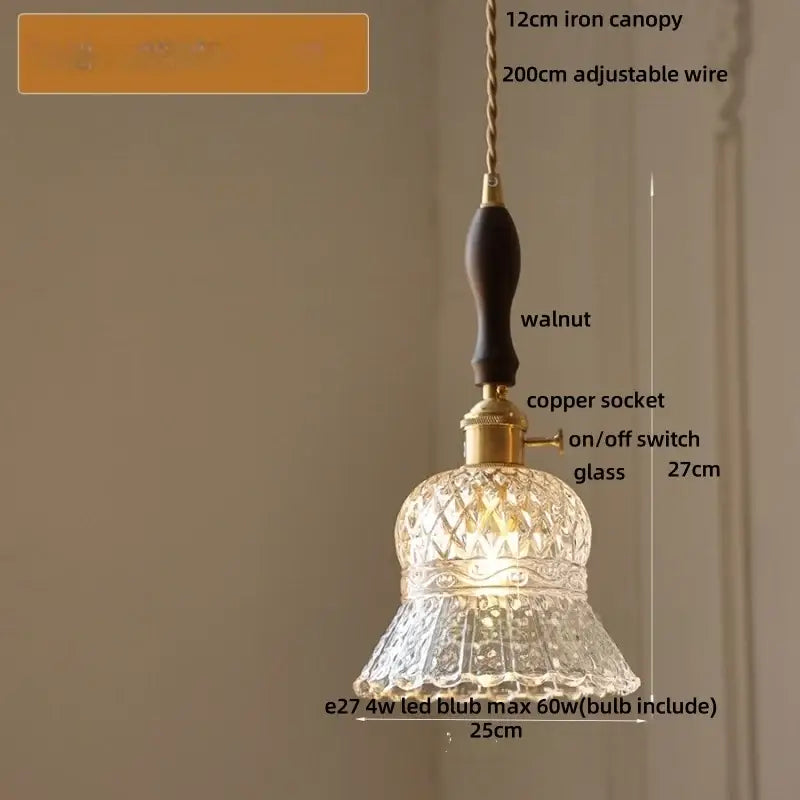 A clear decorbites amber glass led pendant light with an intricately cut glass shade brass copper socket and walnut handle