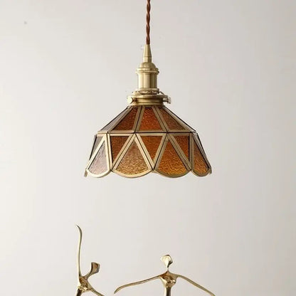 Antique brass pendant light with amber glass led panels and braided cord in a nordic modern copper suspension design