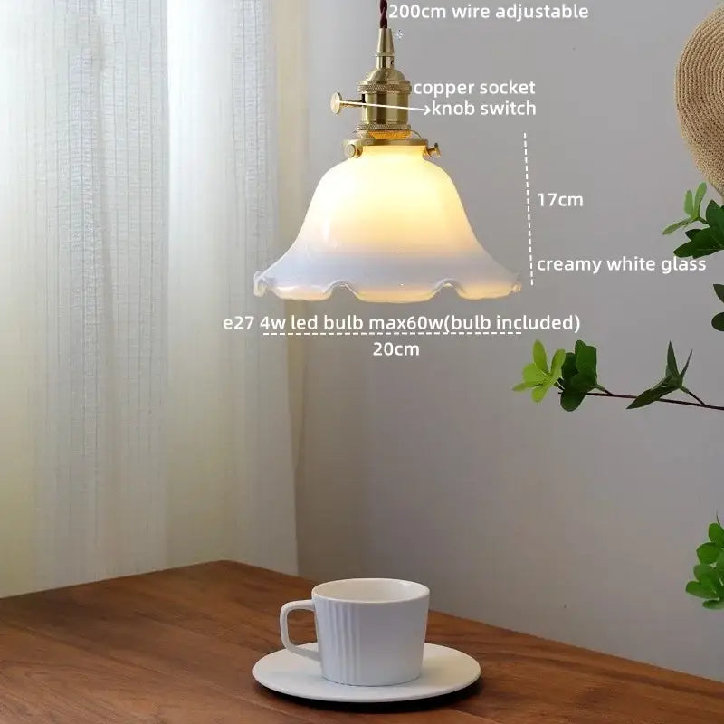 Vintage-style decorbites pendant light with creamy white glass shade and brass finish amber glass led component