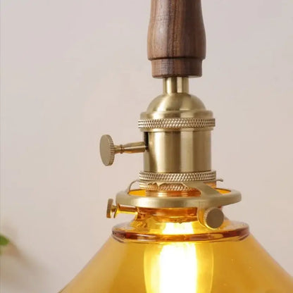 DecorBites amber glass LED pendant light with warm amber glass, brass fixture, and walnut handle for dining and living room