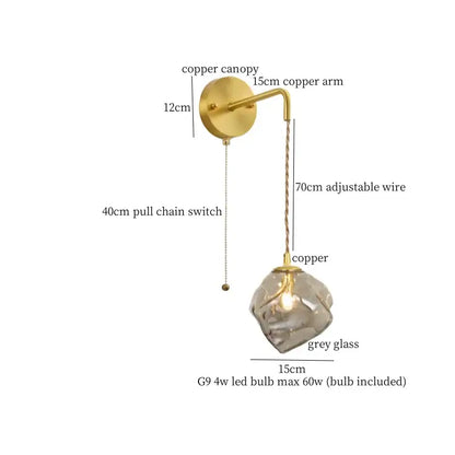 A modern DecorBites amber glass wall light with copper finish, faceted grey glass shade, and adjustable wire