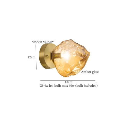 A decorbites amber glass led wall light featuring a warm amber irregularly faceted glass sconce with copper canopy