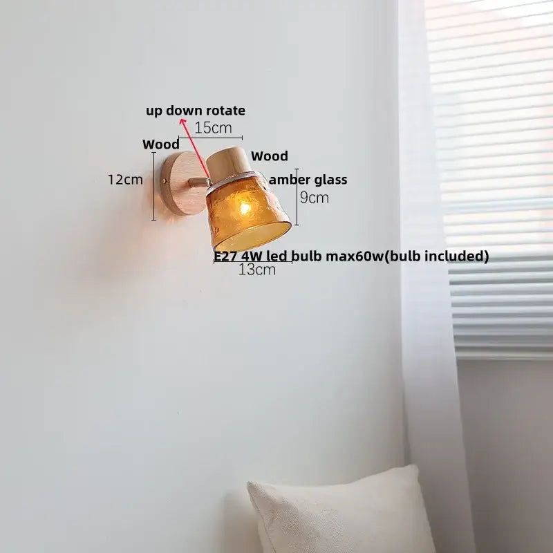 A warm amber glass led wall sconce by decorbites with natural wood base and adjustable arm for nordic modern decor