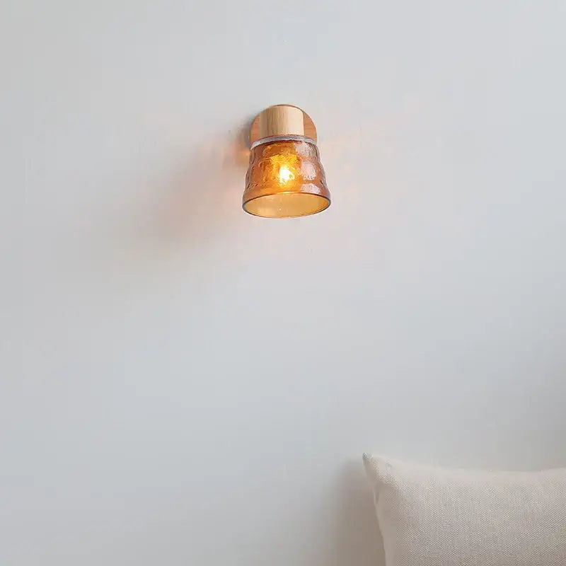 Warm amber glass LED wall sconce by DecorBites with copper metal base and pull chain switch for Nordic modern wood stairs
