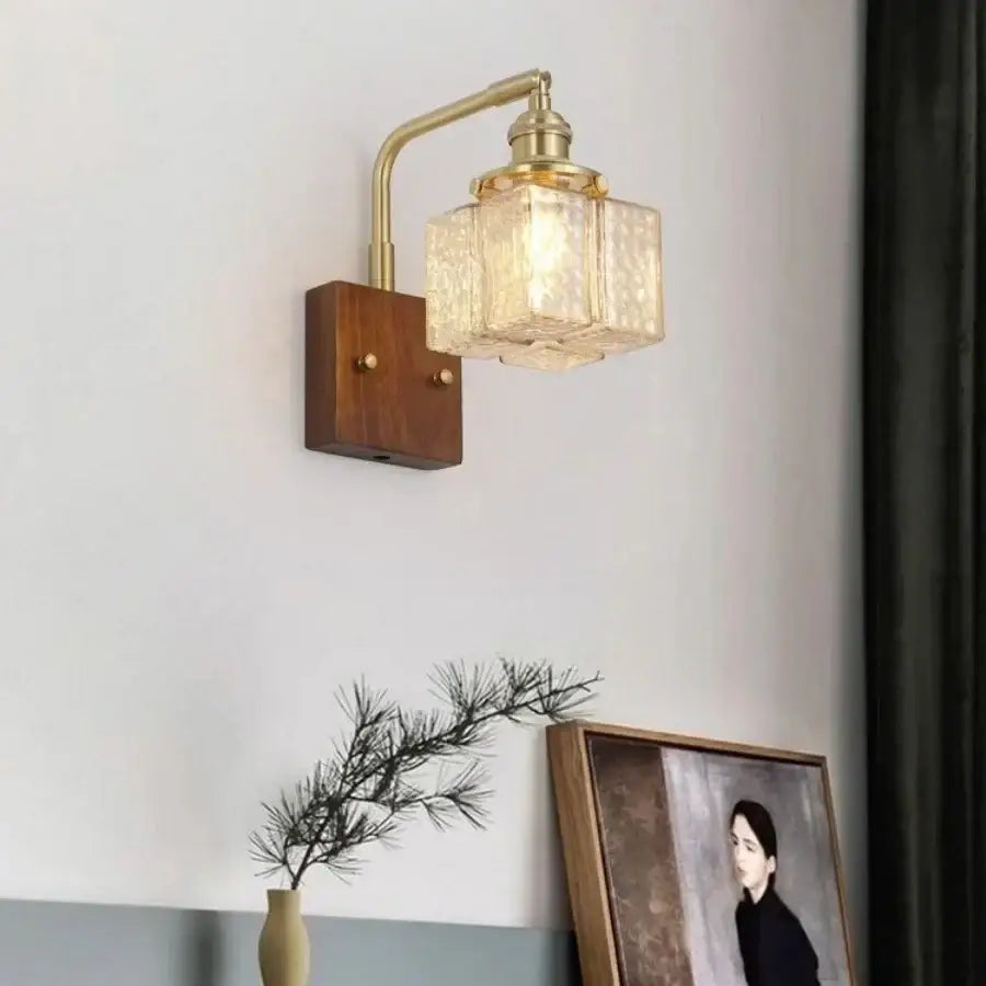 Decorbites™ amber glass led wall sconce with brass finish textured shade and walnut wood base for living room