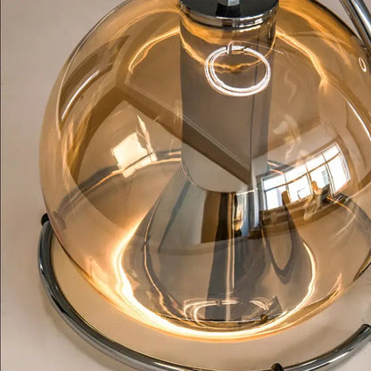 A decorbites amber glass pendant light with amber tinted glass dome and polished chrome base for versatile indoor use