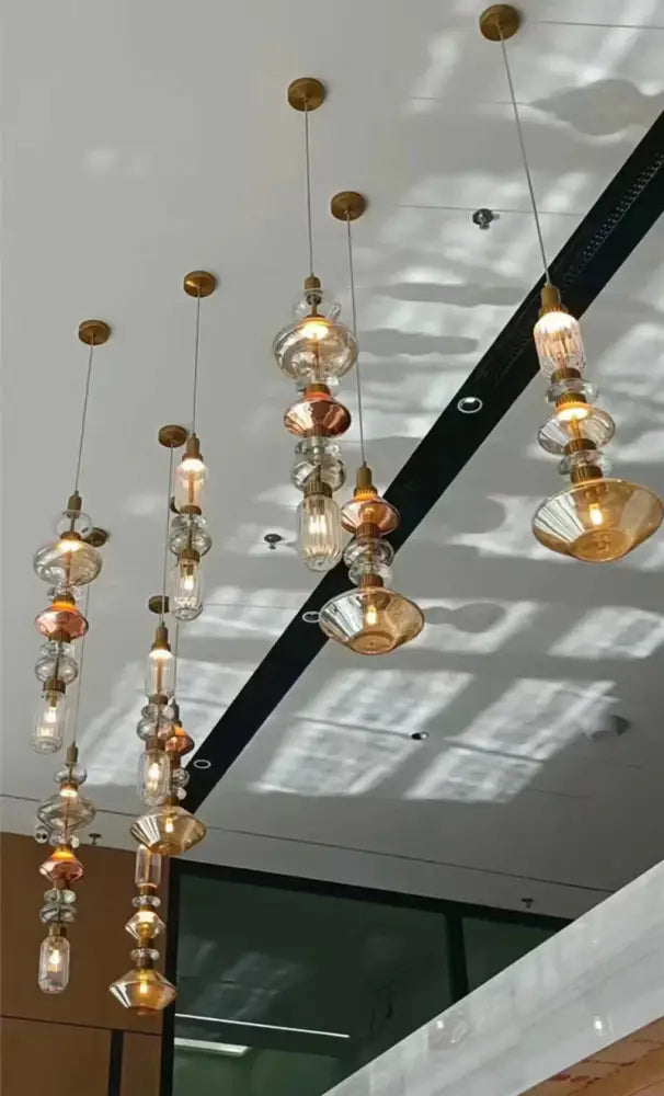 Decorbites amber glass pendant light with cascading amber and clear glass bulbs and brass ceiling fixtures for hotel use
