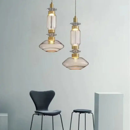 Two elegant decorbites amber glass pendant lights with clear and smoked glass shades and gold metal fittings