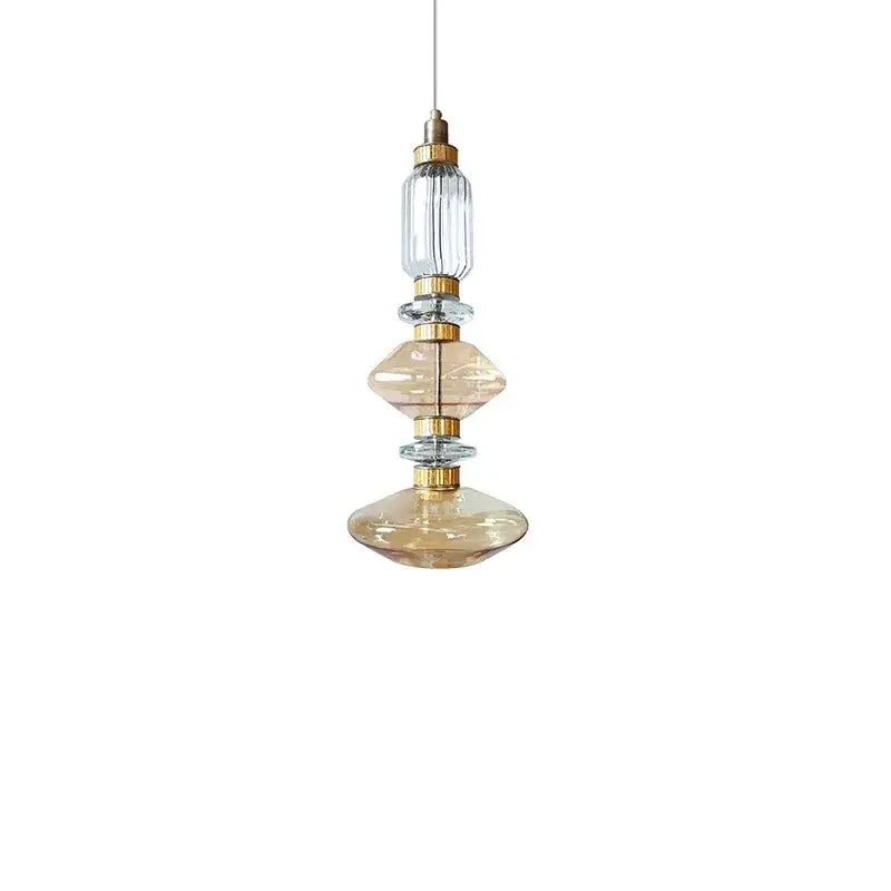 Decorbites amber glass pendant light with stacked amber and clear glass orbs and gold metal accents for hotel bedroom use