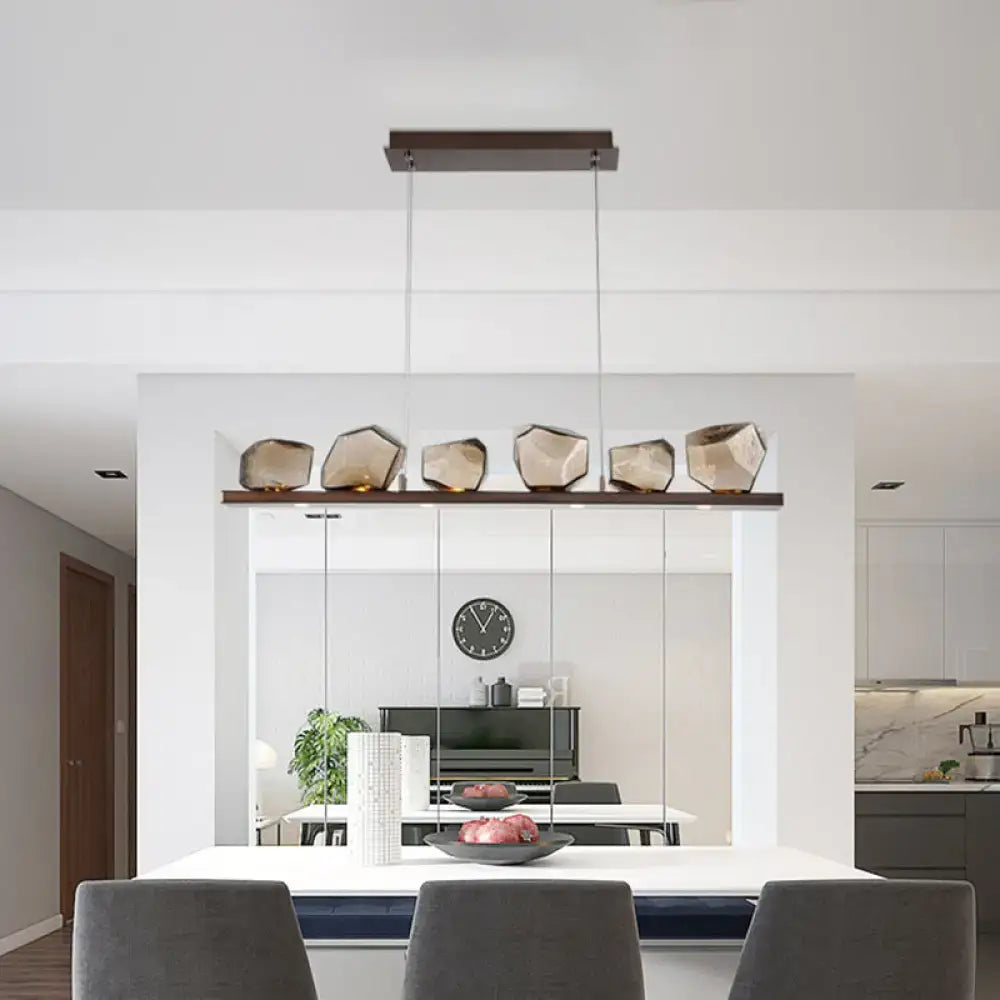 Modern geometric pendant light with amber glass stone shades mounted on dark wood bar for 220v-240v or 110v-120v use