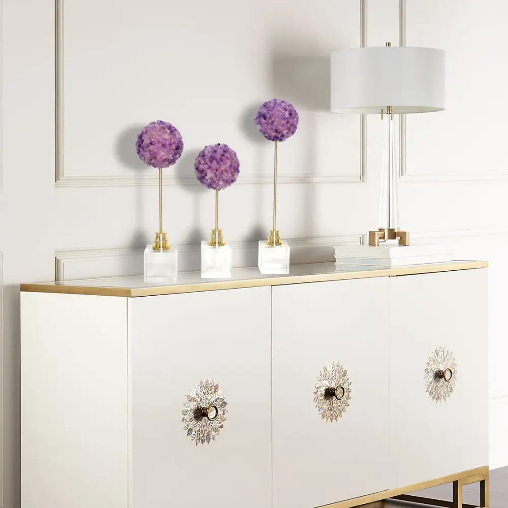 Decorbites amethyst flower metal sculpture features three elegant purple hydrangea pom-poms on gold stems in white marble bases