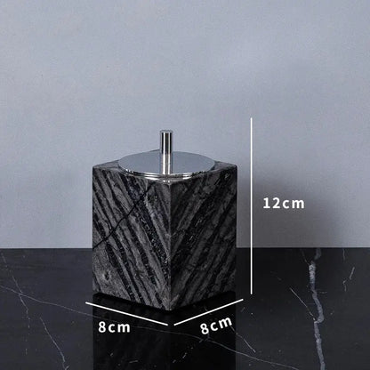 Black marble cube-shaped toilet paper holder with polished chrome lid and rod from DecorBites ancient wood grain set