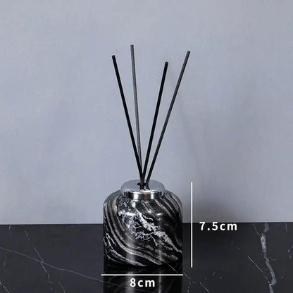 Black and white marble-patterned reed diffuser with silver cap from decorbites ancient wood grain bathroom set