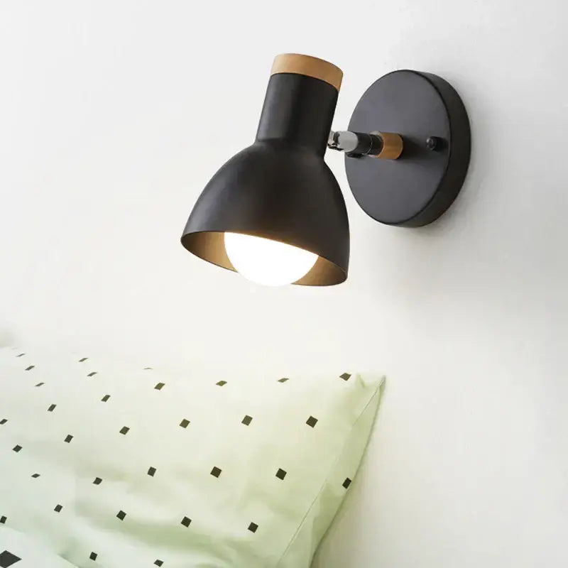Decorbites angel adjustable led wall sconce with black metal and wooden accents featuring a warm glowing bulb