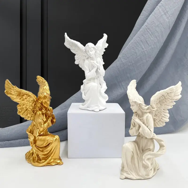 Golden angel figurine with detailed wings and flowing robes white gold resin collectible statue for home decor