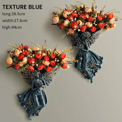 DecorBites™ dark blue resin angel vase wall decoration with intricate wings holding red and peach roses for living room