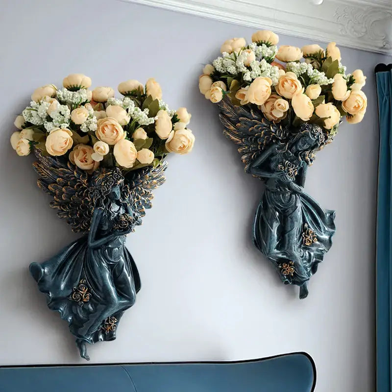 Dark teal resin angel vase wall decoration with ornate wings holding cream roses for living room wall decor