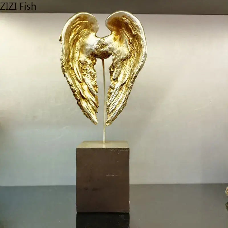 DecorBites angel wings sculpture features textured metallic golden wings on a dark brown base for desk decor