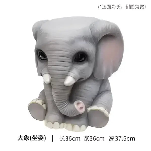 Gray ceramic elephant sculpture footstool seat with white tusks and pink ears in a cute sitting pose by DecorBites