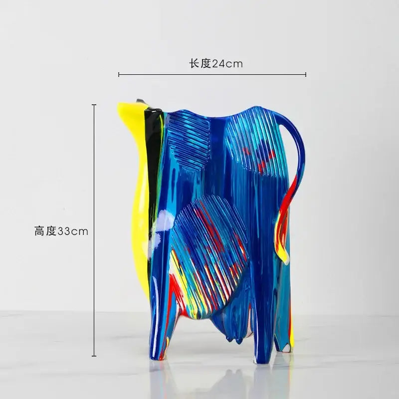 Vibrant blue glass animal resin statue cow with yellow red and black accents from decorbites resin statue collection