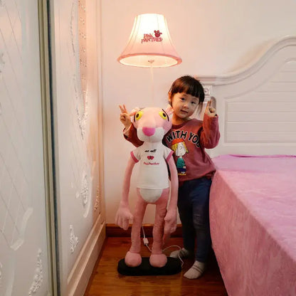 DecorBites™ animal shape led floor lamp featuring a pink panther plush with white shirt on a black base for children’s room