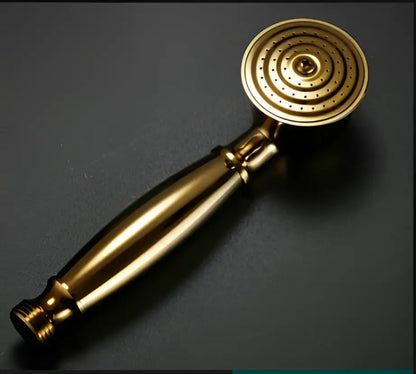 Gold-colored brass decorbites antique bathroom handheld shower head with circular textured face and elongated handle for high pressure rainfall