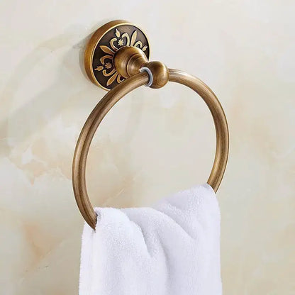 Antique brass towel ring with ornate floral engraving on mounting plate in decorbites bath hardware and towel rack set