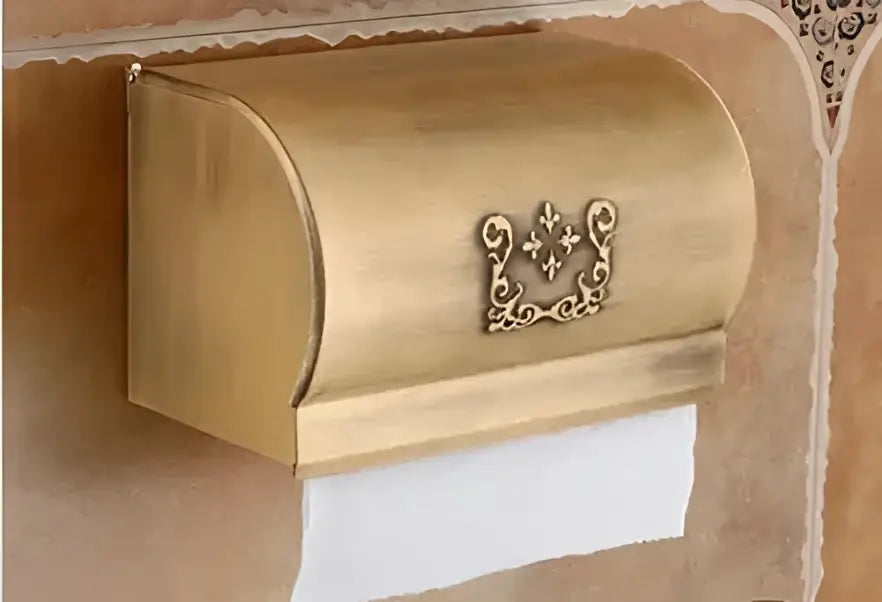 Gold-colored ornate metal toilet paper holder with fleur-de-lis emblem from decorbites™ bath hardware set with towel rack and toilet brush holder