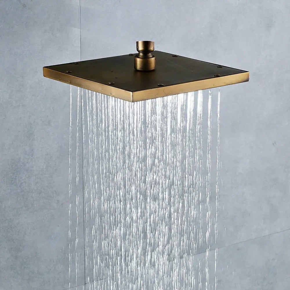 Decorbites antique brass 8-inch square rainfall shower head with central knob and multiple water streams in antique brass finish