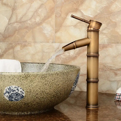 Decorbites antique brass bamboo basin faucet single handle with sleek segmented design and flowing spout in antique brass