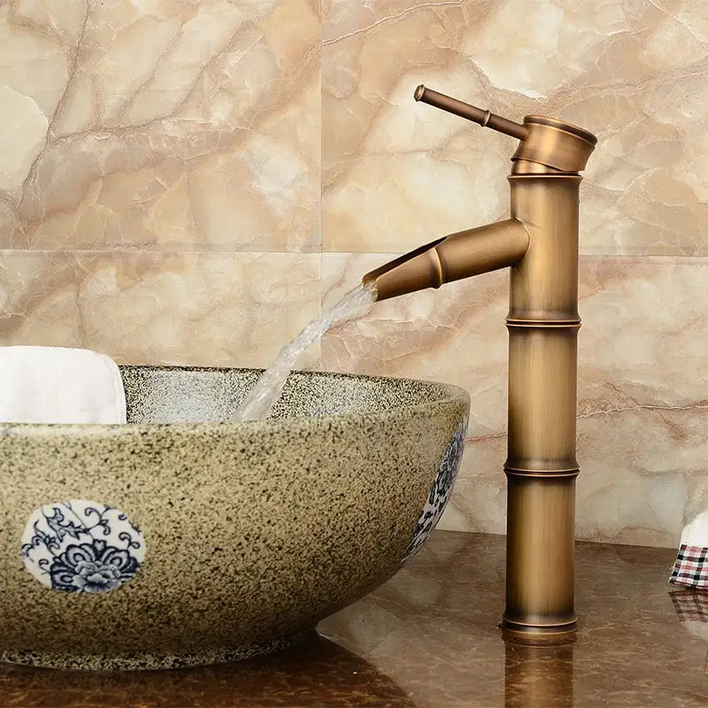 Decorbites antique brass bamboo basin faucet single handle with sleek segmented design and flowing spout in antique brass