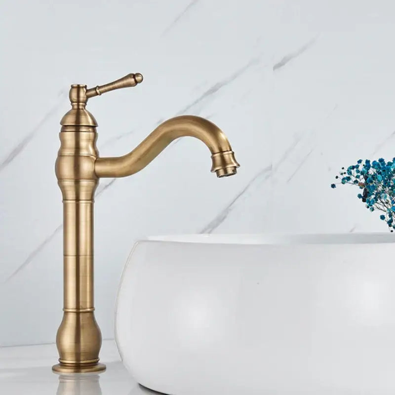 DecorBites antique brass basin faucet with single handle curved spout and ornate detailing for bathroom sink