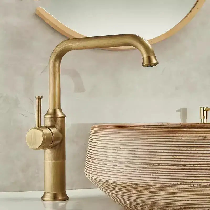 Decorbites antique brass basin faucet with single lever and curved spout for bathroom sink use in antique brass finish