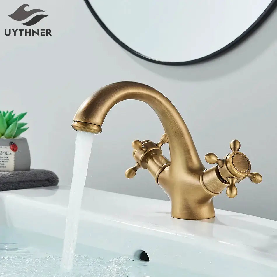 Decorbites antique brass basin faucet with solid brass construction, ornate cross handles, and curved spout for bathroom use