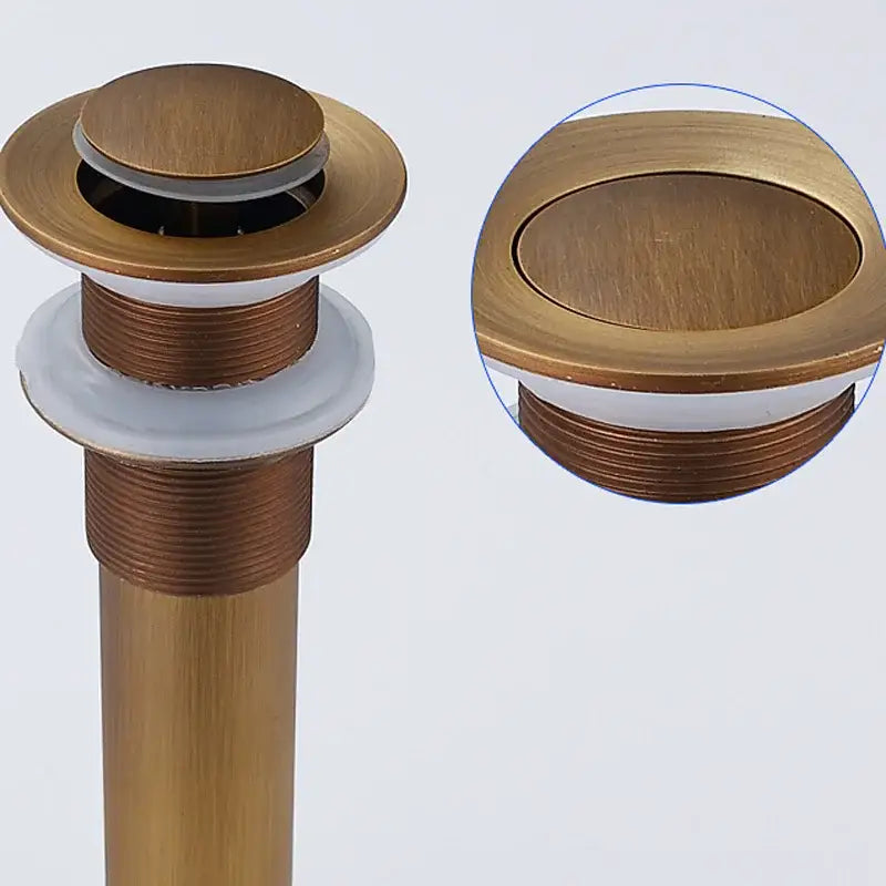 Brass-finished antique brass basin sink drain stopper with brushed metallic surface and threaded cylindrical body