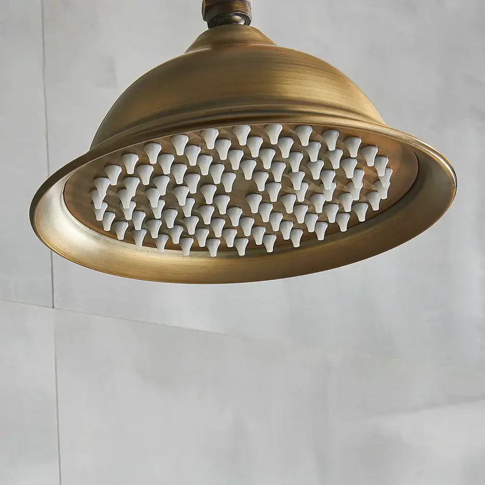 Decorbites™ antique brass bath rainfall shower head with brass finish and white ceramic nozzles in an 8 inch round design