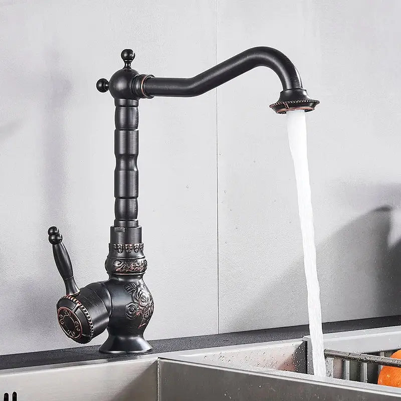 Antique brass bathroom sink faucet mixer by decorbites with ornate floral detailing and curved spout in black brass