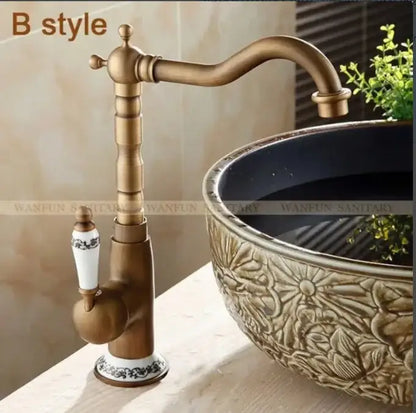 Decorbites antique brass bathroom sink faucet with white ceramic handle and black floral detailing single handle mixer