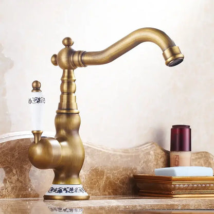Decorbites antique brass ceramic handle basin faucet with ornate detailing and floral white ceramic handle