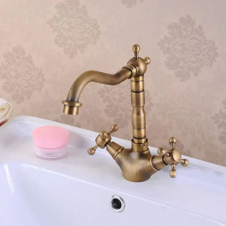 Antique brass double cross handle basin faucet with curved spout and 360 degree swivel for kitchen use
