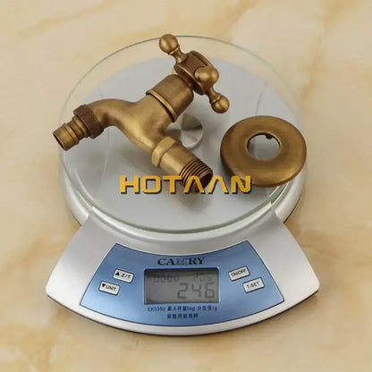 Decorbites™ antique brass finish wall mount garden bibcock faucet with matching flange on digital scale in brass finish