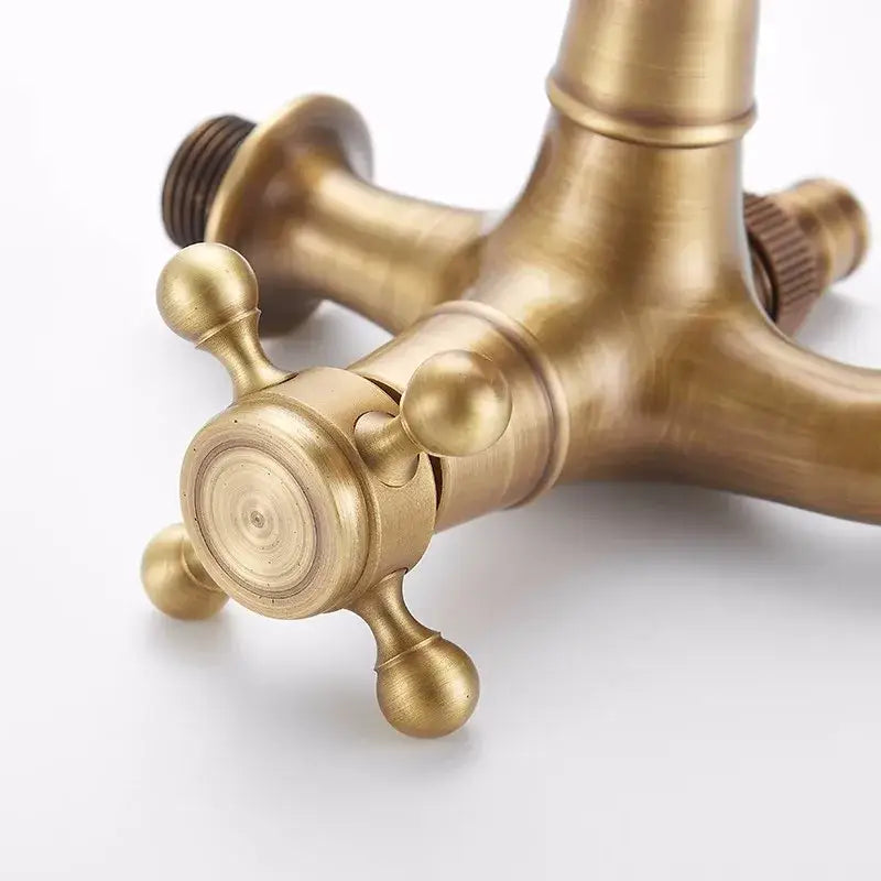 Decorbites antique brass garden bibcock with cross-handle knobs and central spout for outdoor use