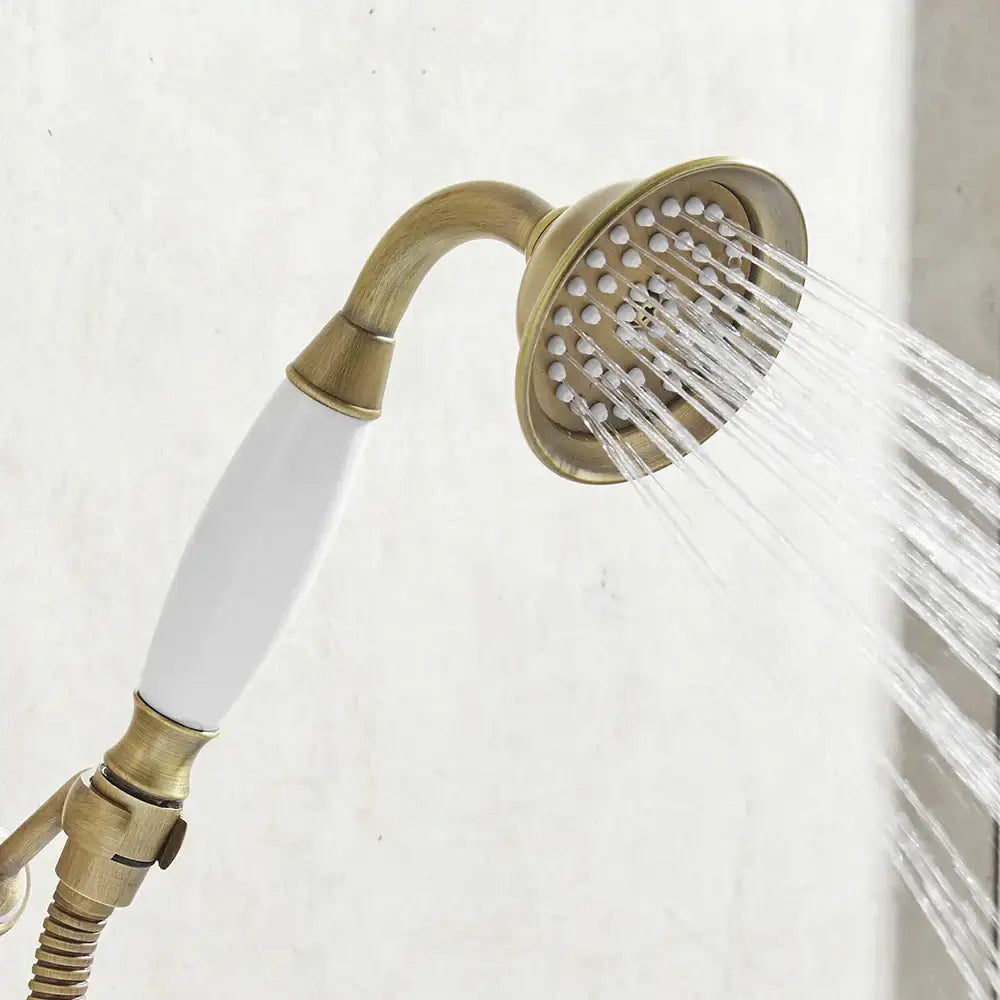 DecorBites antique brass hand held shower with white ceramic handle and multiple spray nozzles for rainfall use