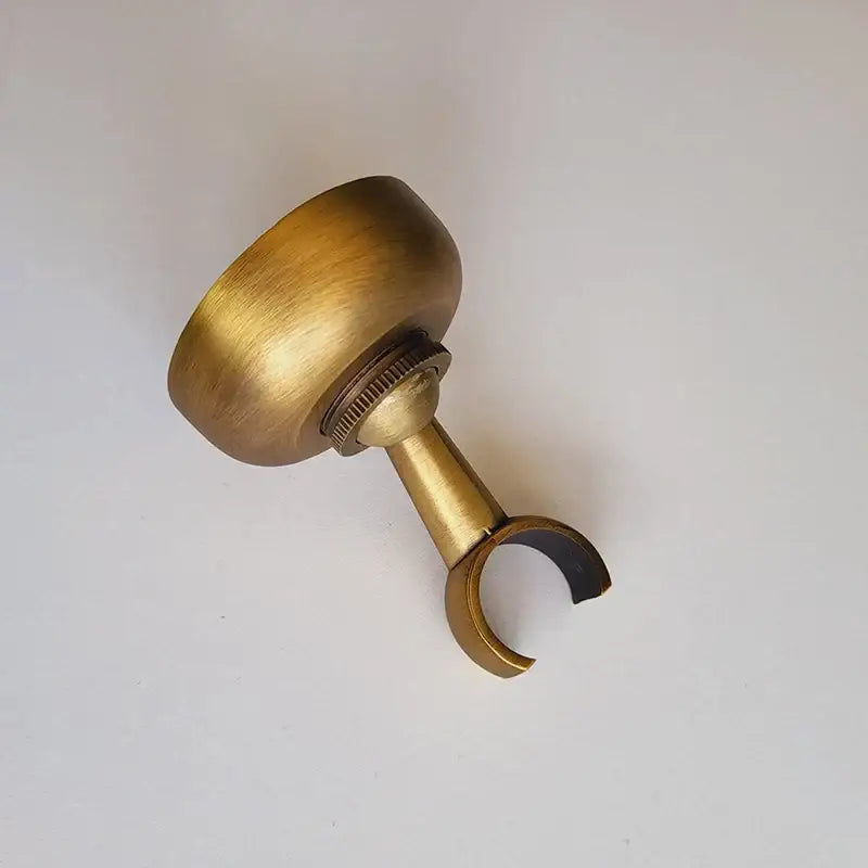 DecorBites™ antique brass hand shower holder with rounded top, threaded adjustment, and curved holder hook pedestal